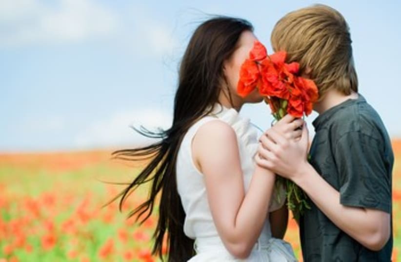 couple kissing with flowers 370 (photo credit: Thinkstock/Imagebank)