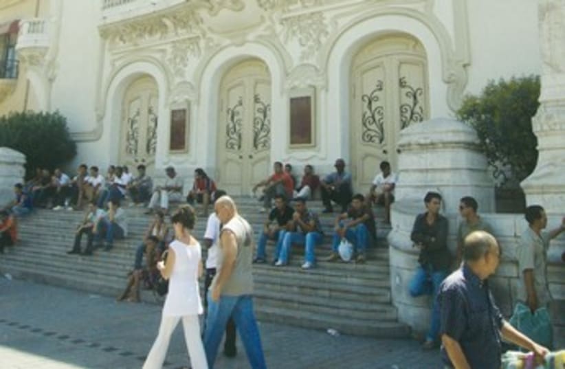 Tunisians sit on the steps of the opera house 370 (photo credit: Seth J. Frantzman)