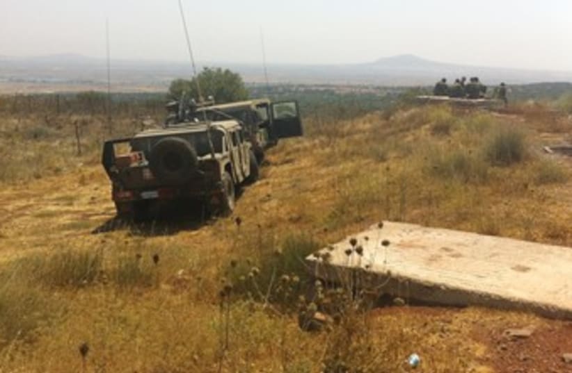 ISRAELI SOLDIERS keep watch over the Syrian border 370 (photo credit: seth frantzman)