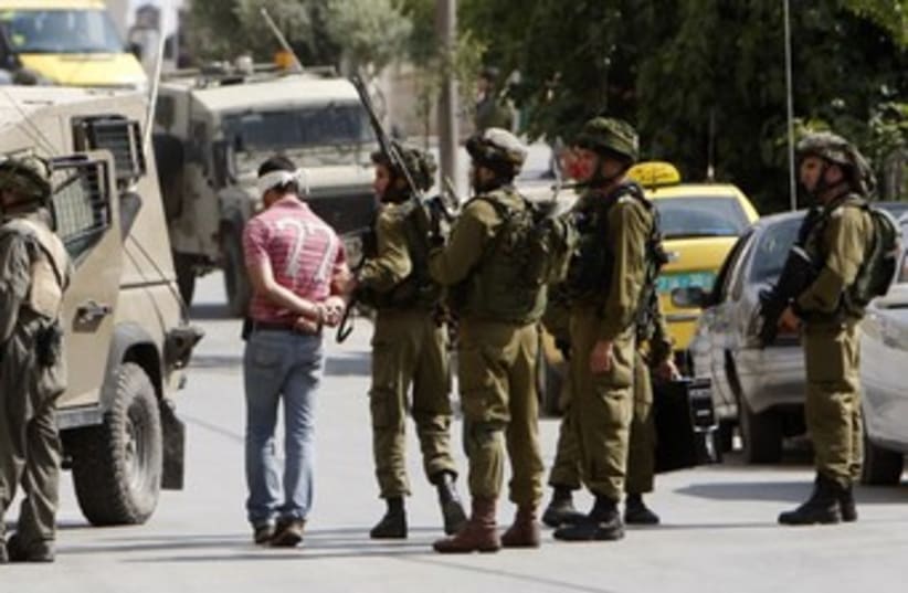 IDF soldiers arrest a Palestinian in Ramallah 370 (R) (photo credit: Mohamad Torokman / Reuters)
