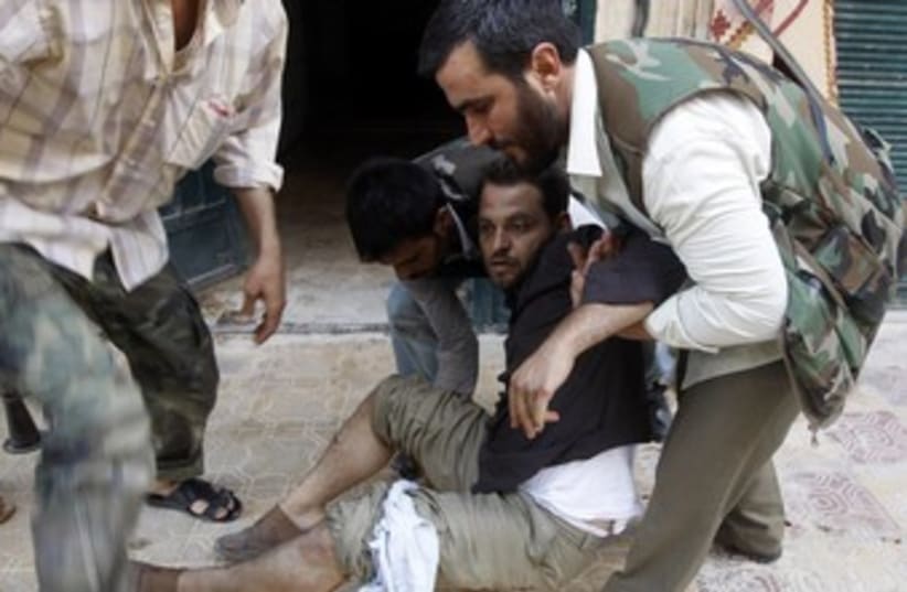 Medics Treat Syria's Wounded (photo credit: Goran Tomasevic / Reuters)