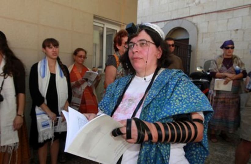 Woman Wearing Tefillin Holding Prayer Book 390 (photo credit: Marc Israel Sellem /The Jerusalem Post)