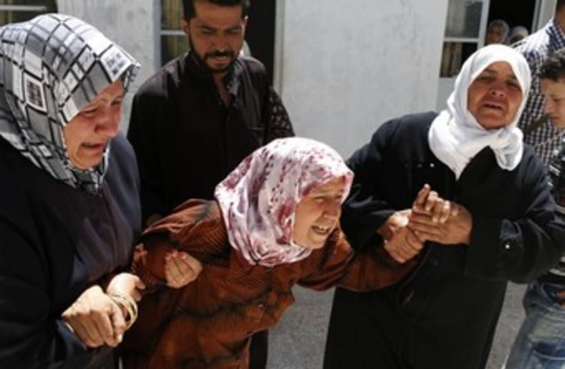 Syria mother crying (R370) (photo credit: REUTERS/Youssef Boudlal)