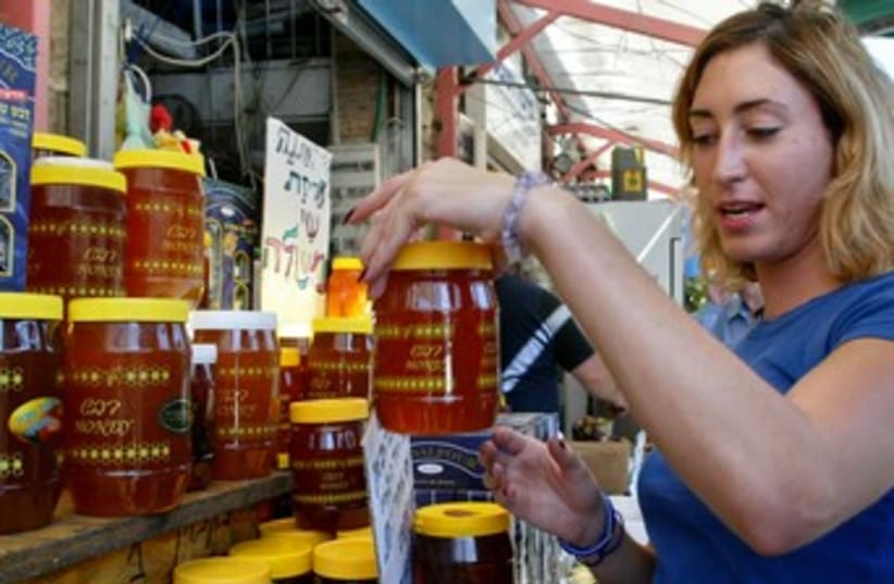 Buying honey (photo credit: Reuters)