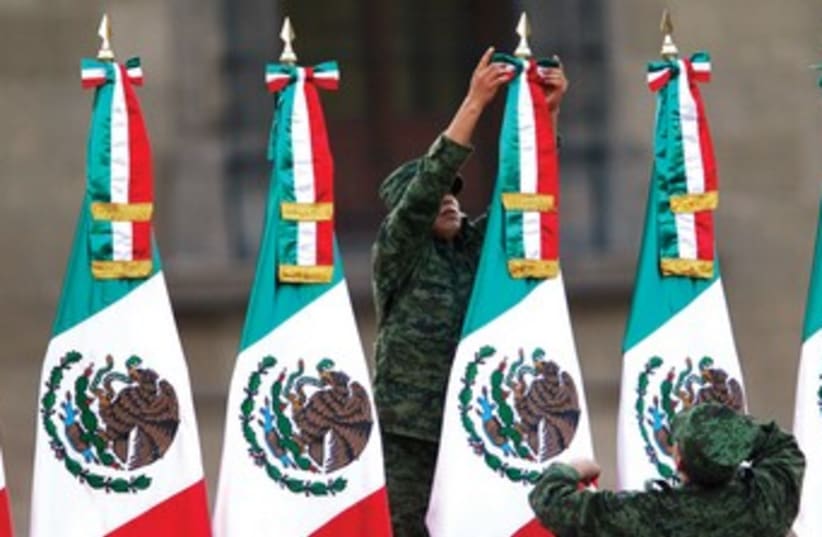 Soldiers Mexican flags 370 (photo credit: Tomas Bravo/Reuters)