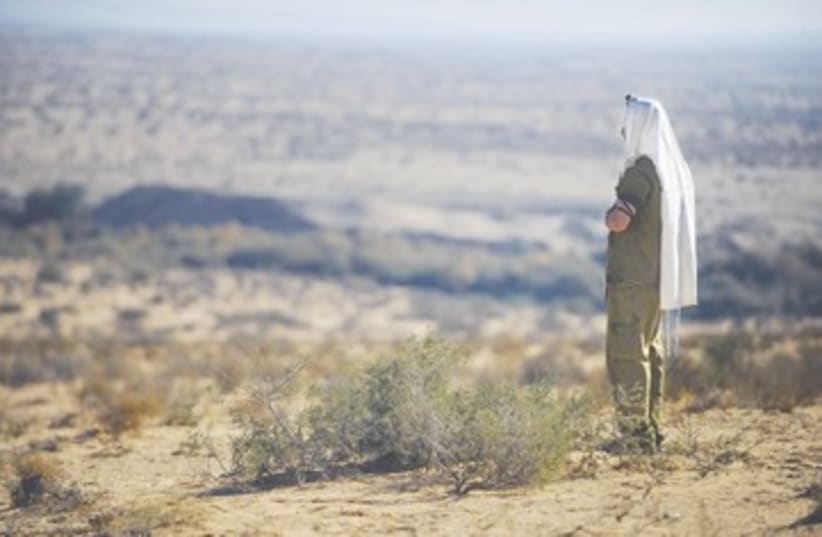 A haredi soldier prays during a drill (photo credit: IDF Spokesman))