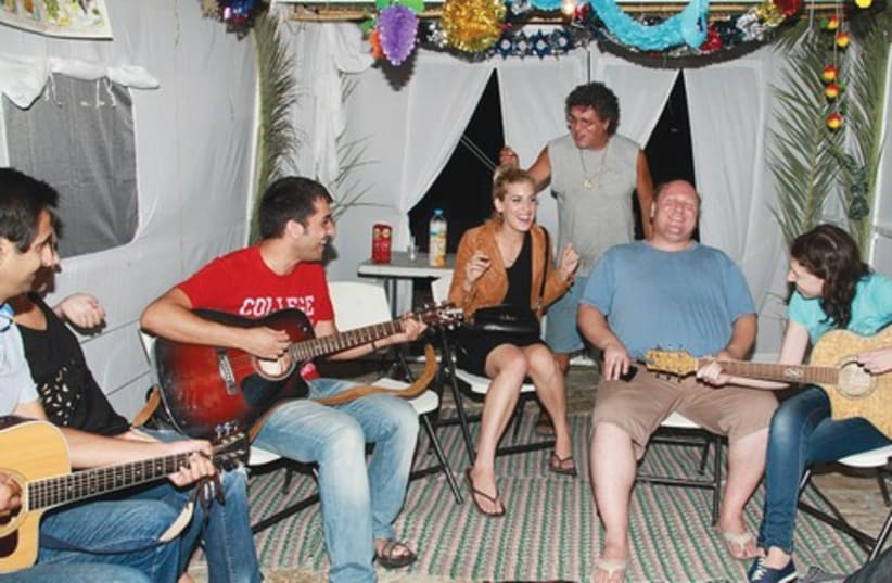 Jam session in public succa (photo credit: Moshe Goldberg)