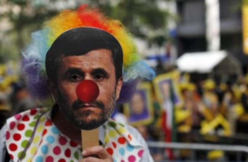 Protesters wear mask of Ahmadinejad [illustrative] 370 (photo credit: REUTERS/Eduardo Munoz)