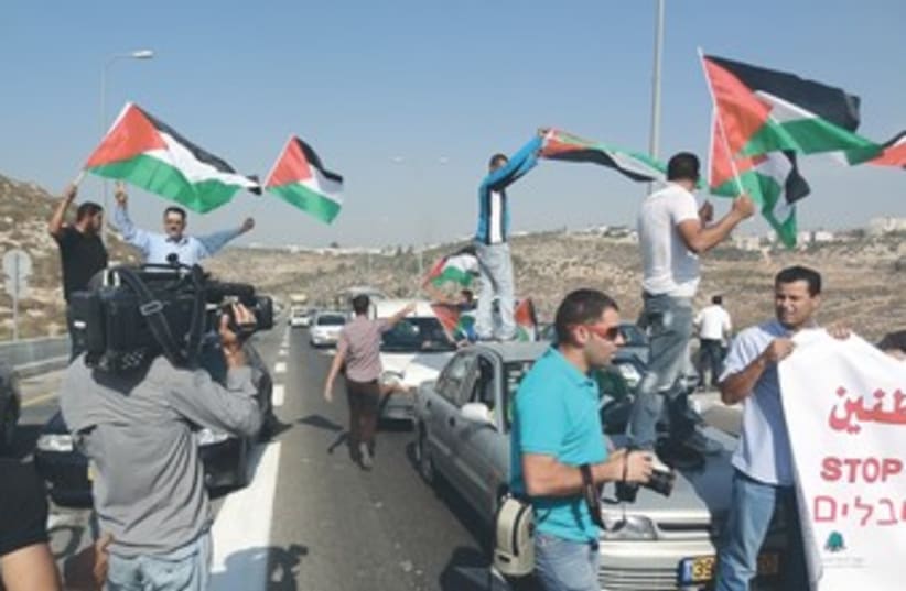 Palestinians, activists block Route 443 370 (photo credit: Marshall Pinkerton)