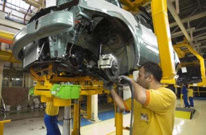 Iranian employees assemble car in Tehran plant 370 (photo credit: Miro Maman)