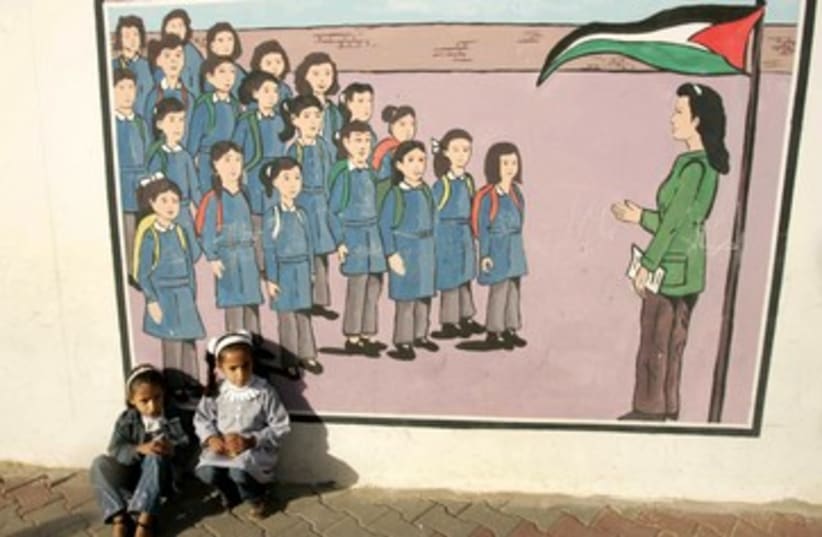 Palestinian kids sit at UNRWA school 370 (photo credit: REUTERS/Ibraheem Abu Mustafa)