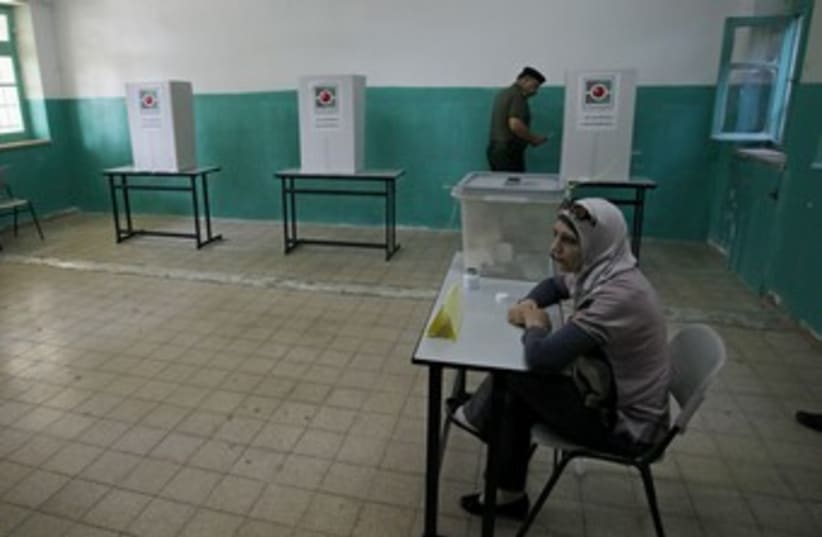 A Palestinian votes in local elections in Ramallah 370 (R) (photo credit: Mohamad Torokman / Reuters)
