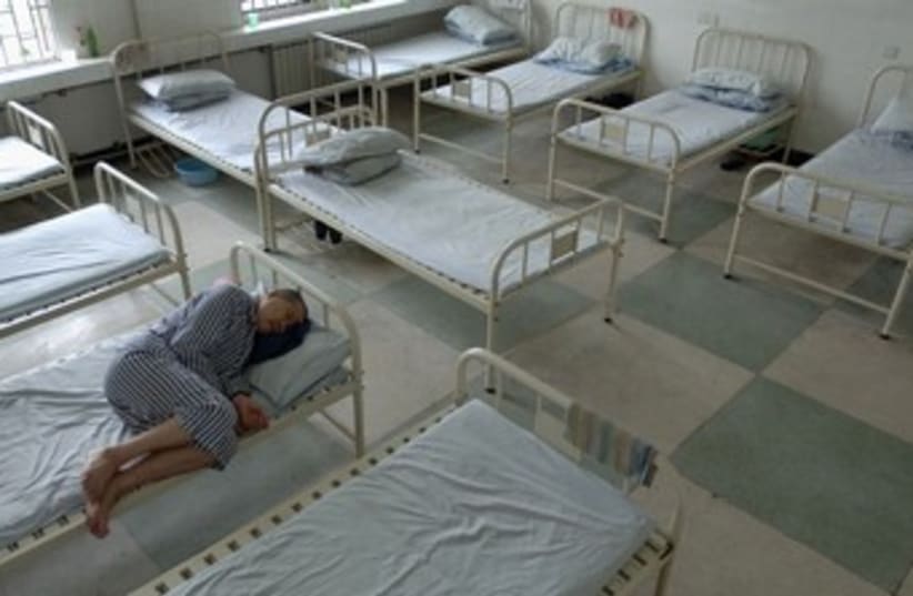 Mental health inmate rests in bed [illustrative] 370 (photo credit: REUTERS/Jianan Yu)