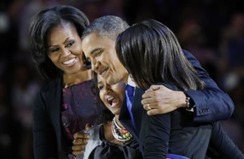 Obama hugs his family after winning re-election 370 (R) (photo credit: Larry Downing / Reuters)