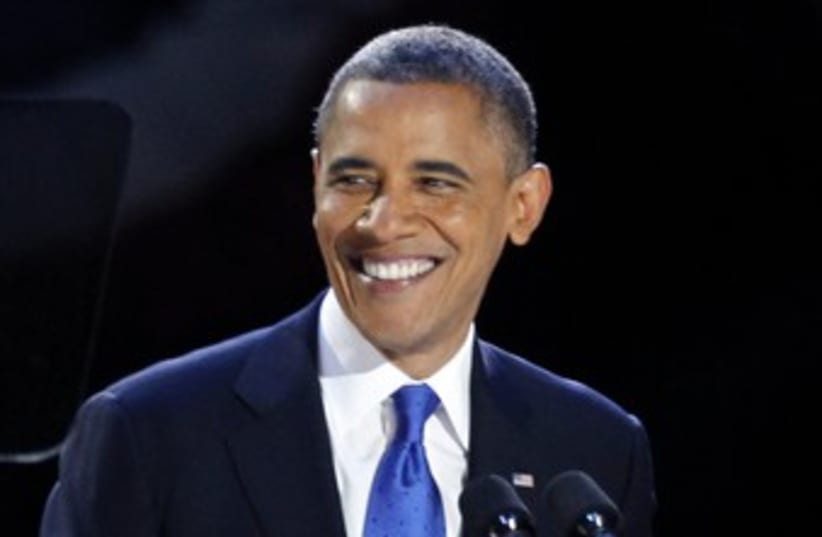 Obama smiles after winning re-election 370 (R) (photo credit: Jim Bourg / Reuters)
