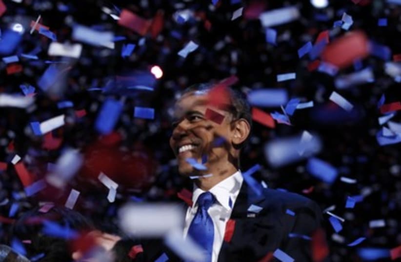 Obama celebrates election win (photo credit: Kevin Lamarque / Reuters)
