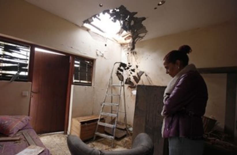 Tami Shadadi surveys damage to her Sderot house (photo credit: REUTERS/Amir Cohen)