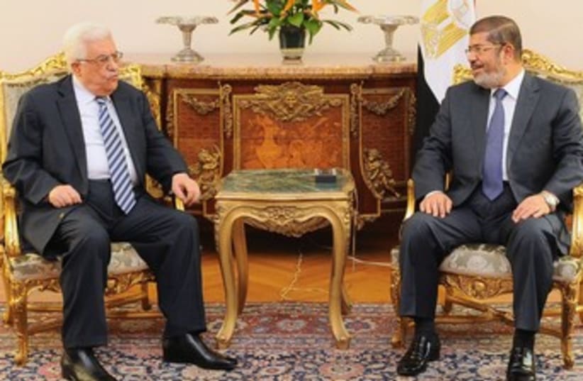 Mahmoud Abbas with Mohamed Morsi in Cairo 370 (R) (photo credit: Reuters / handout)