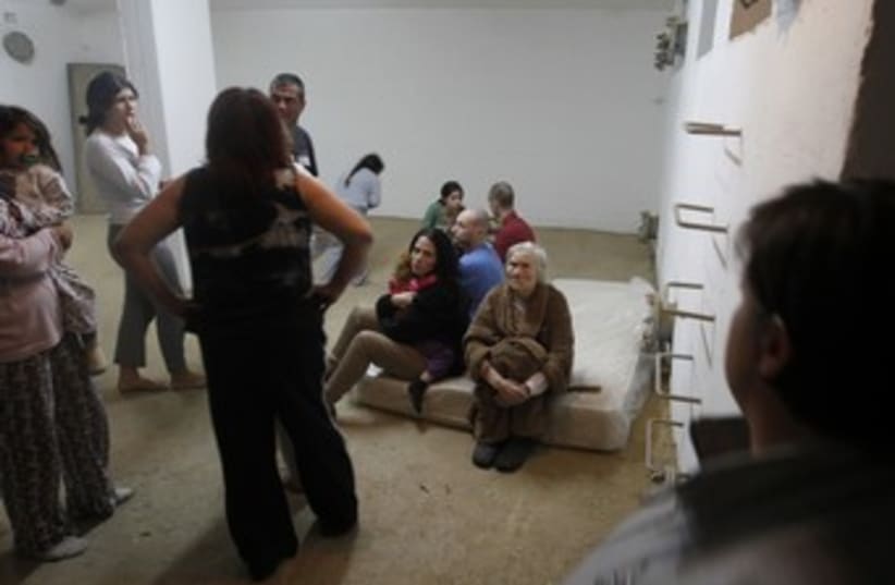 Israelis in Beersheba sit in a bomb shelter 370 (R) (photo credit: Baz Ratner / Reuters)