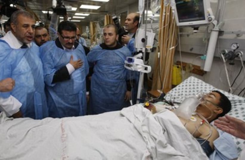 Tunisian FM Rafik Abdessalem visits Gaza wounded 390 (photo credit: REUTERS/Ahmed Zakot)