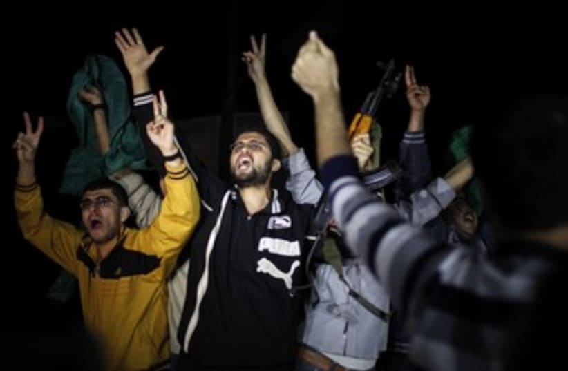 Gazans celebrate after cease-fire 370 (photo credit: Reuters)