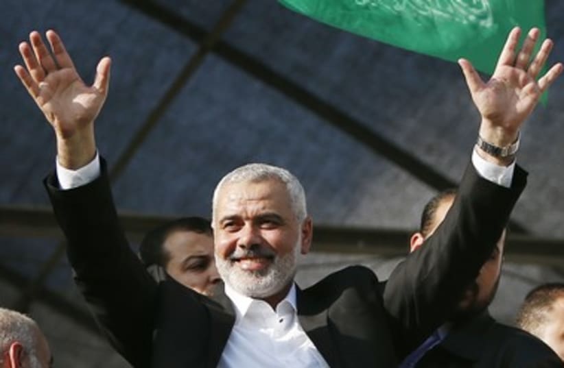  Hamas PM Ismail Haniyeh waves to people as they celebrate 3 (photo credit: REUTERS)