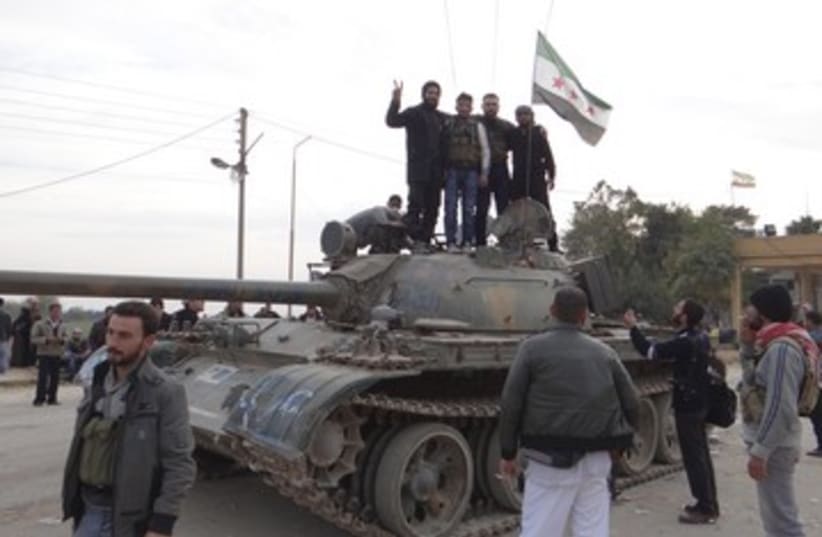 Free Syrian Army on tank DECEMBER 370 (photo credit: REUTERS)