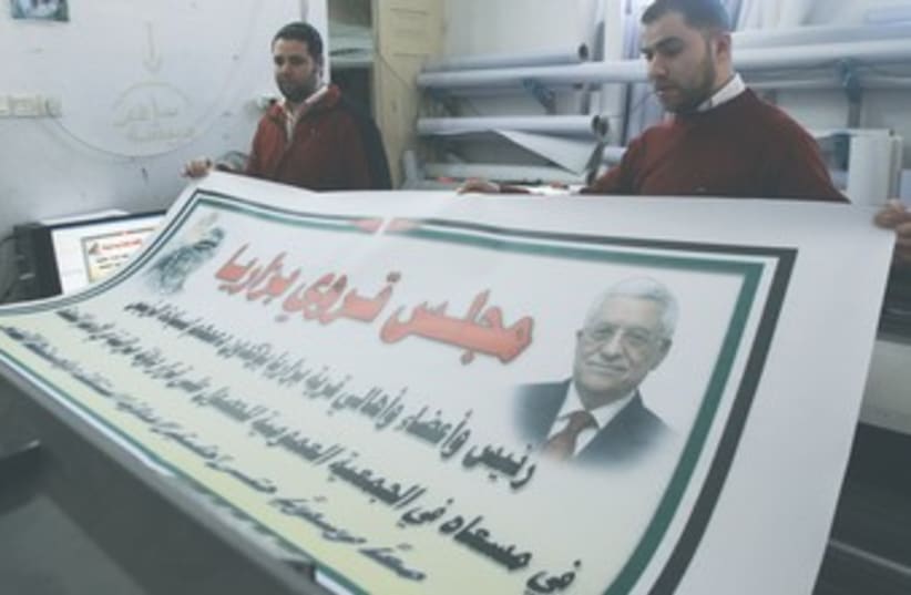 Nablus men hold poster of Abbas and Arafat 370 (photo credit: Abed Omar Qusini/ Reuters)