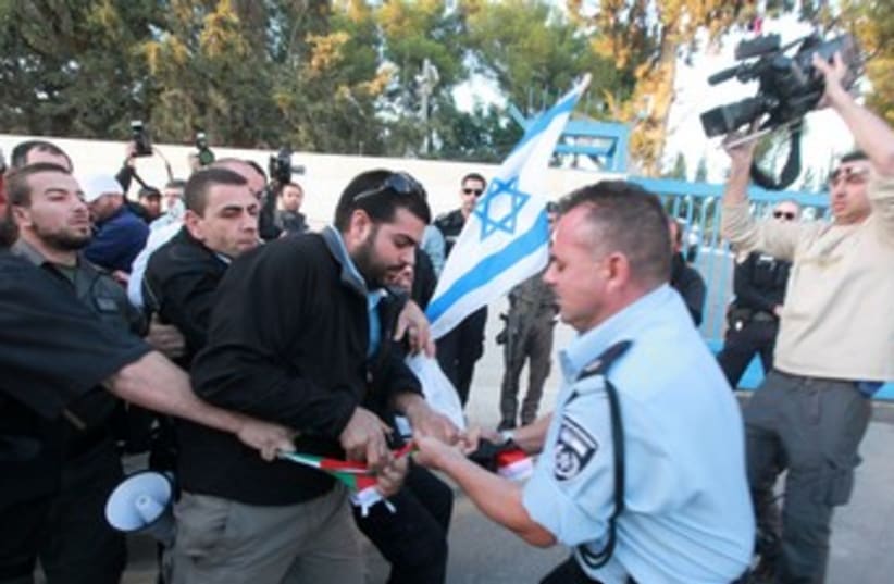 Police snatch flag from protester who tried to burn it 370 (photo credit: Marc Israel Sellem/The Jerusalem Post)