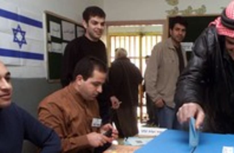 Israeli-Arab man casts his vote elections voting 300 (R) (photo credit: Ammar Awad / Reuters)