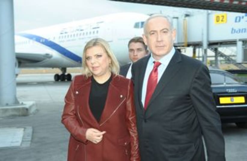 PM Netanyahu departs from B-G Airport with wife Sarah 370 (photo credit: GPO / Amos Ben-Gershom)