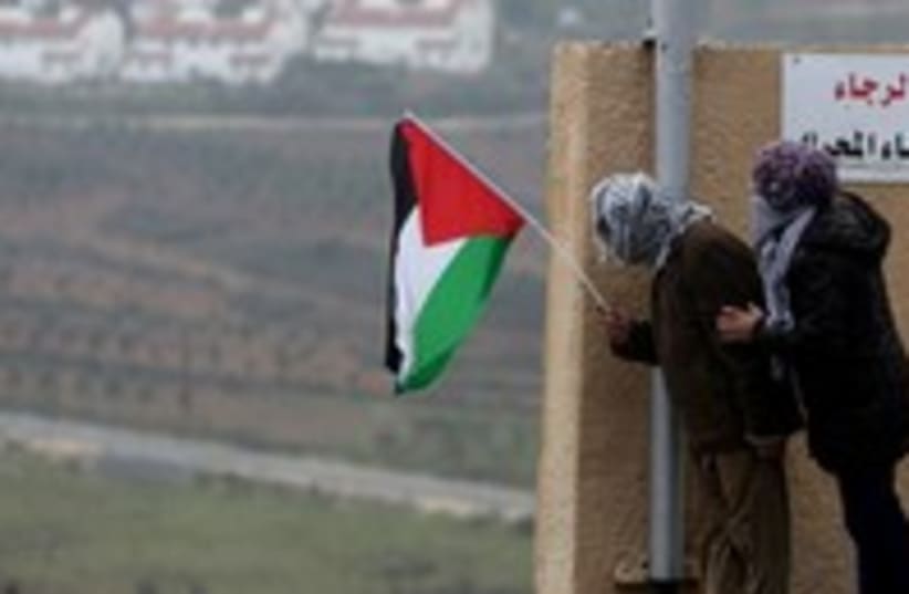 Palestinians hold a flag in the West Bank 300 (photo credit: Reuters/Mohamad Torokman)