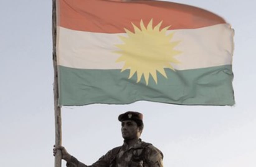 Kurdish soldier flag 370 (photo credit: Azad Lashkari/Reuters)