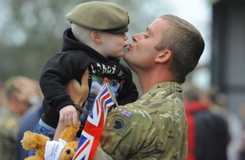 British soldier with son 370 (photo credit: REUTERS/Nigel Roddis)