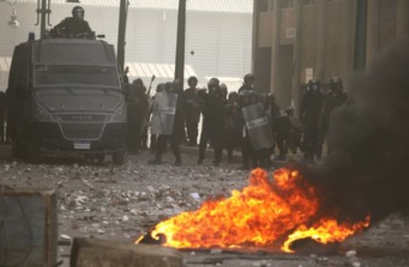 police throw stones at protesters in Alexandria 370 (photo credit: REUTERS/Asmaa Waguih)
