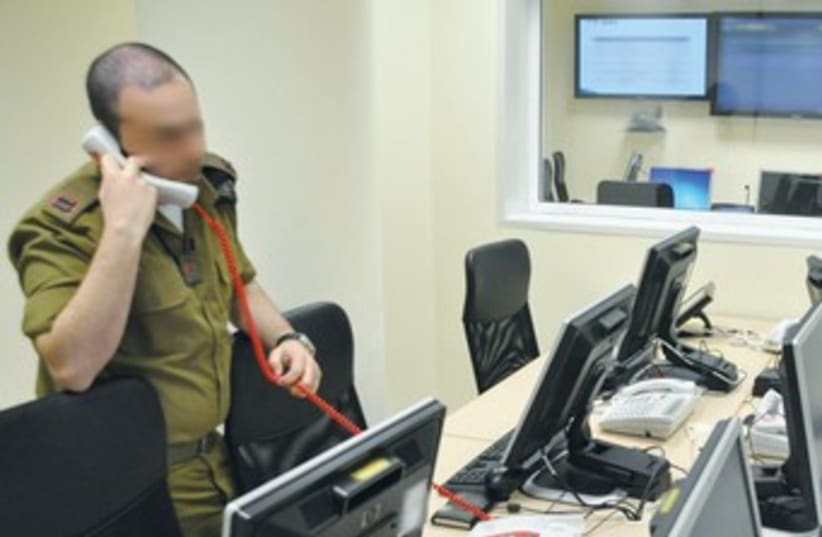 IDF officer on phone, computers 370 (photo credit: IDF Spokesman’s Office)