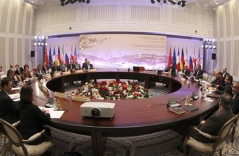 Participants sit at a table during talks on Iran (photo credit: REUTERS/Stanislav Filippov)