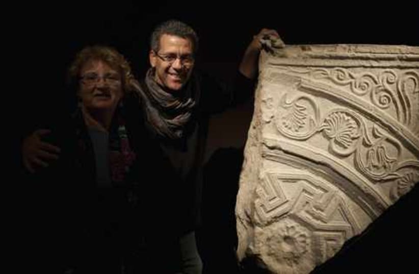 Curators with the Hulda gate 521 (photo credit: ELIE POSNER/THE ISRAEL MUSEUM)