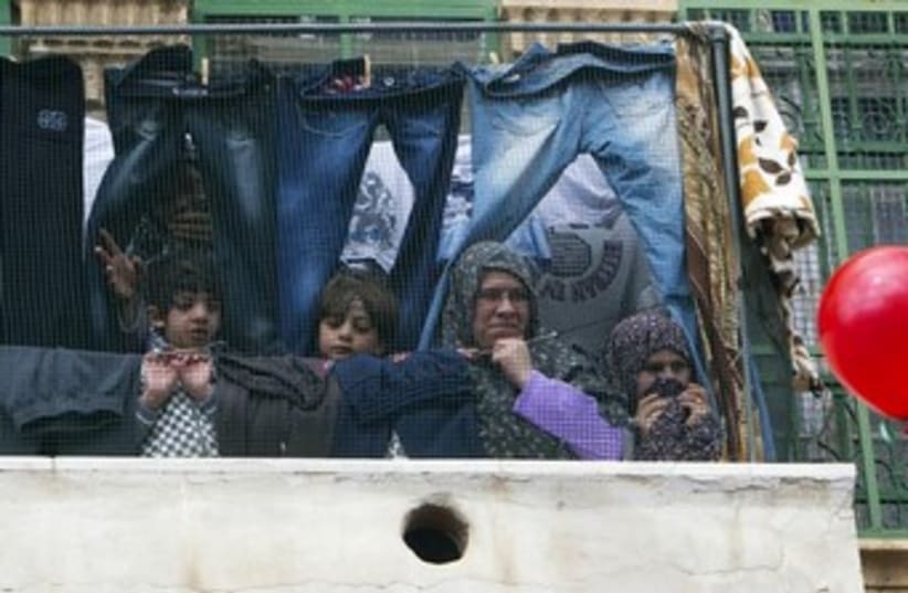 Palestinians in the West Bank (photo credit: REUTERS/Ronen Zvulun)