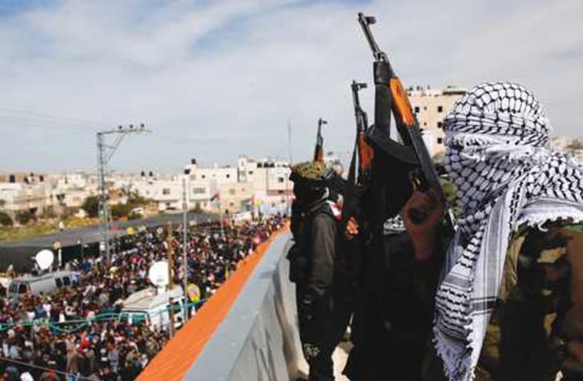 al-Aqsa gunmen at Arafat Jaradat funeral 521 (photo credit: DARREN WHITESIDE / REUTERS)
