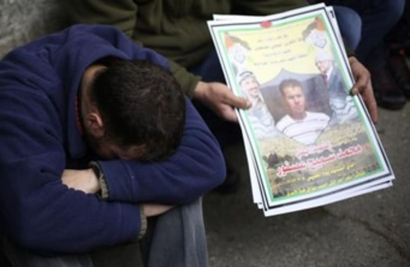 Palestinian man cries at funeral of  Muhammad Asfour 370 (photo credit: REUTERS/Mohamad Torokman)