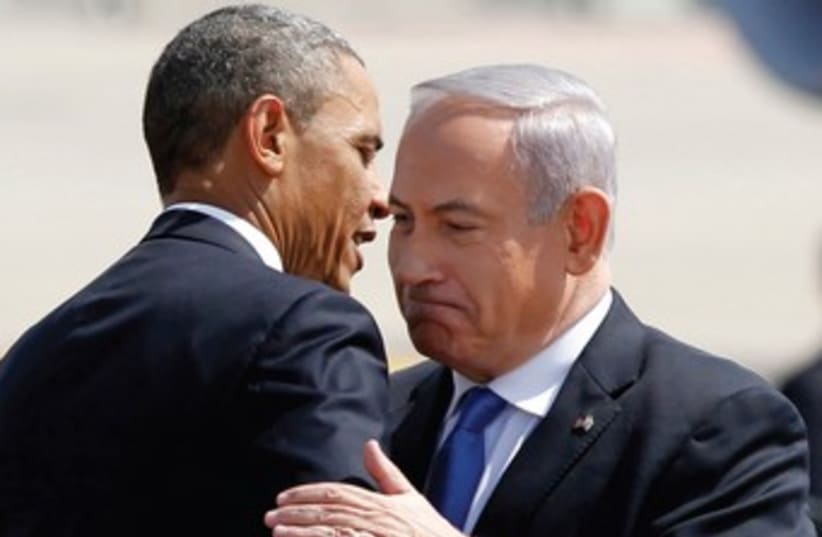 Netanyahu and Obama embrace 370 (photo credit: Jason Reeed/Reuters)