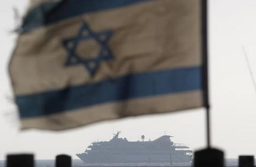 Mavi Marmara; Israeli flag, ship in background 370 (photo credit: REUTERS/Amir Cohen)