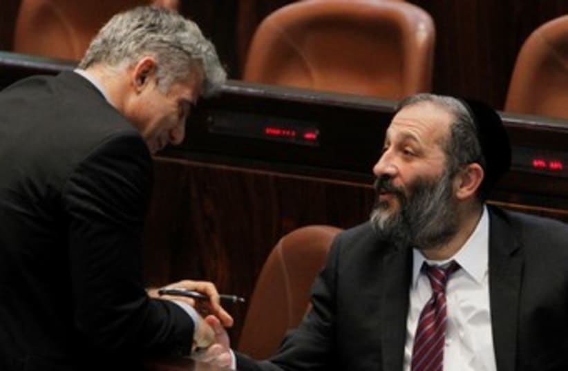 Lapid shaking hands with Deri at Knesset 370 (photo credit: Marc Israel Sellem/The Jerusalem Post)