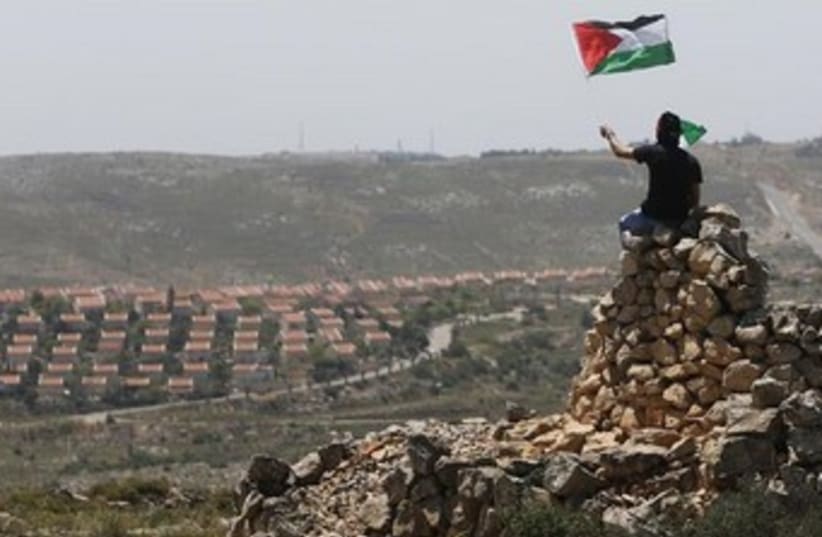 Palestinian with flag W. Bank370 (photo credit: REUTERS/Mohamed Torokman)