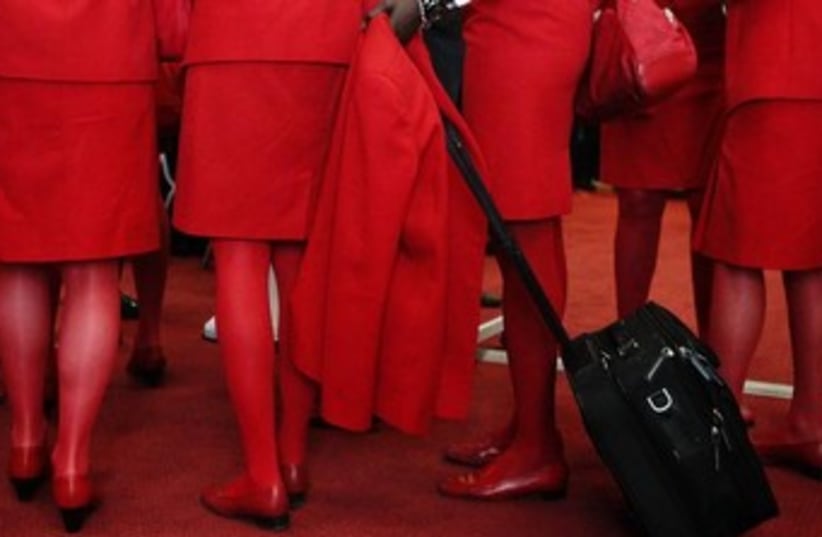 Airline stewardesses wearing red (photo credit: REUTERS/Heinz-Peter Bader)