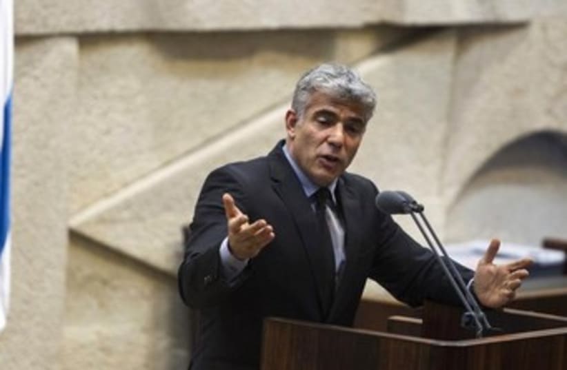 Lapid addressing the knesset 370 (photo credit: REUTERS)
