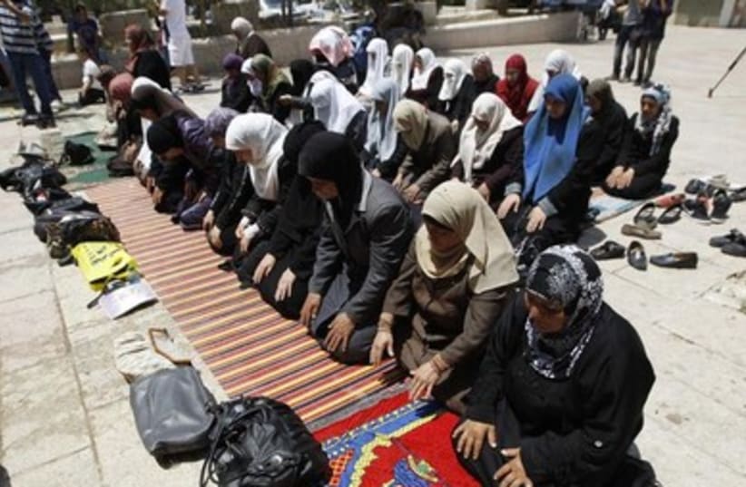 Palestinian women pray outside the Temple mount 390 (photo credit: REUTERS)