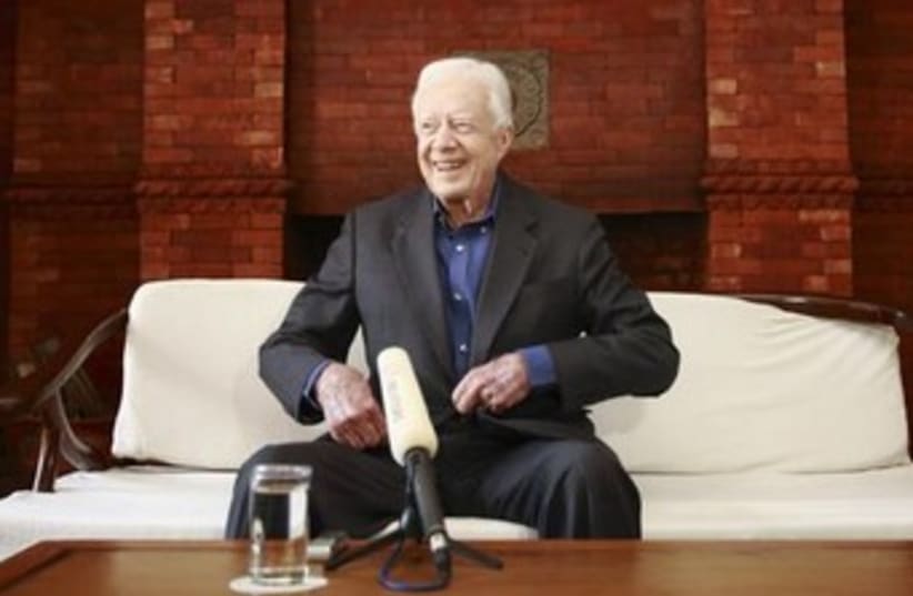 Jimmy carter smiling from couch 370 (photo credit: REUTERS)
