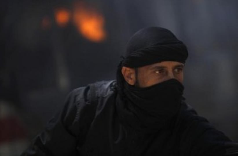 masked syrian rebel fighter 370 (photo credit: REUTERS)
